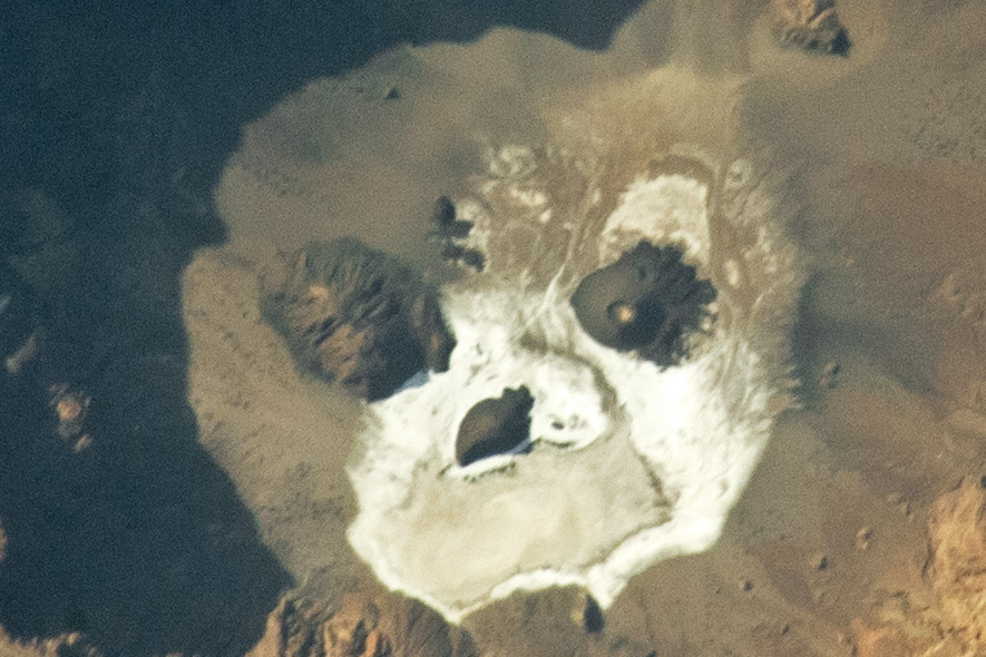 Astronaut Looks Down on Earth From Space Station, a Ghostly Face Stares Back 1 ghost face chad sahara skull iss photo 2